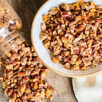 Cinnamon Granola in a round bowl with ball jar