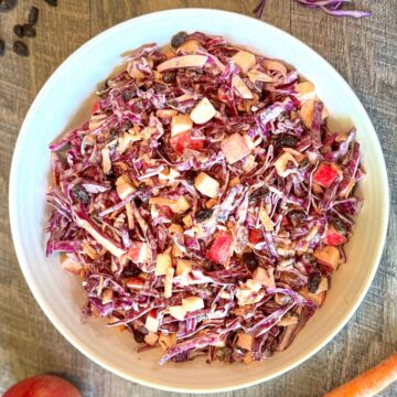 Purple Cabbage Coleslaw with Apples and Cinnamon in white round bowl