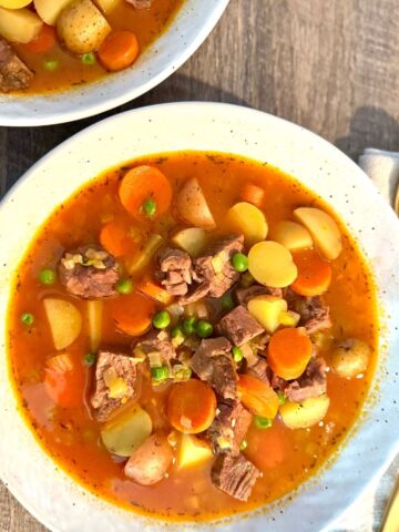 Vegetable beef soup in a round white bowl